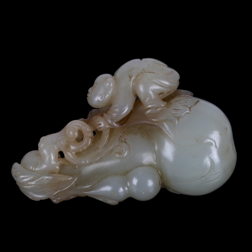 196 - A Chinese carved jade ornament depicting a man climbing a double-gourd, length 8cm