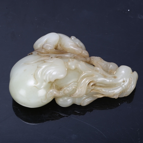 196 - A Chinese carved jade ornament depicting a man climbing a double-gourd, length 8cm