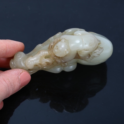 196 - A Chinese carved jade ornament depicting a man climbing a double-gourd, length 8cm