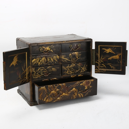 201 - A small Japanese Meiji Period lacquer table cabinet, with gilded butterfly decorated top, shaped rel... 