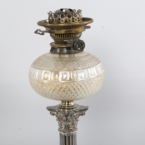 208 - A late 19th century silver plated Corinthian column oil lamp with cut-glass well, with later shade a... 