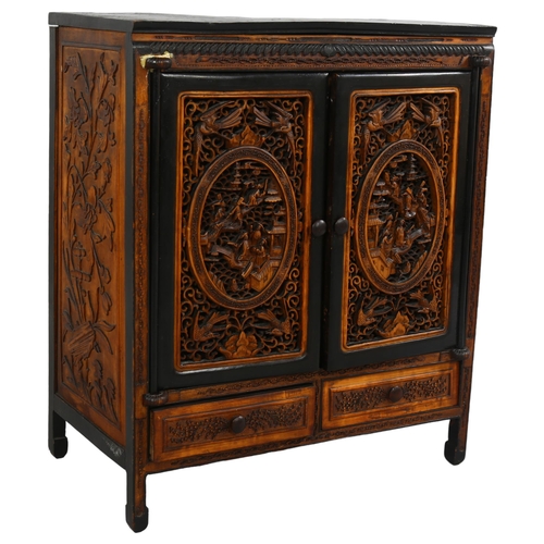 214 - An early 20th century Chinese table-top cabinet, with relief carved panels, ebonised pine constructi... 