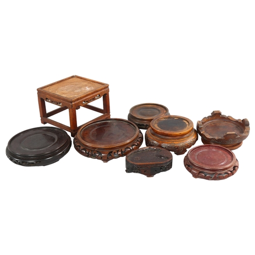 218 - A collection of 8 Chinese hardwood stands, all with carving to edges