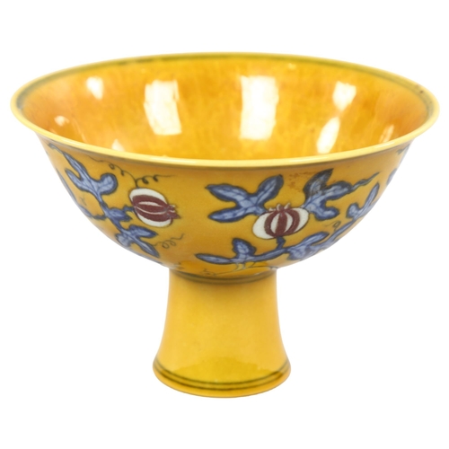 220 - A yellow Chinese stem bowl with blue under-glaze decoration, character marks inside base, height 10.... 