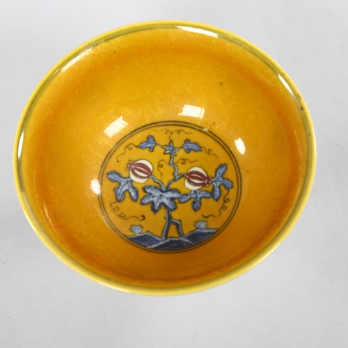 220 - A yellow Chinese stem bowl with blue under-glaze decoration, character marks inside base, height 10.... 