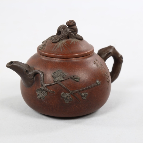 223 - A Chinese Yixing teapot with monkey knop, character marks to base and sides, height 12cm