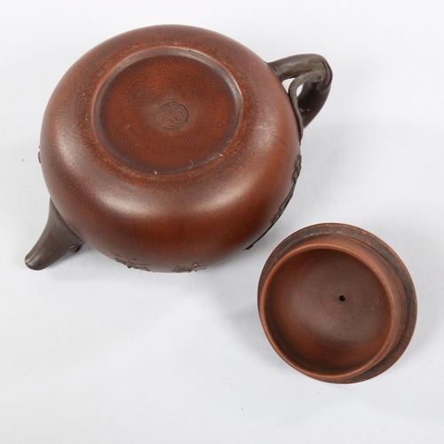 223 - A Chinese Yixing teapot with monkey knop, character marks to base and sides, height 12cm