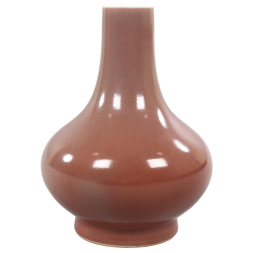 225 - A peach glaze narrow-neck vase, with character marks to base, height 19cm