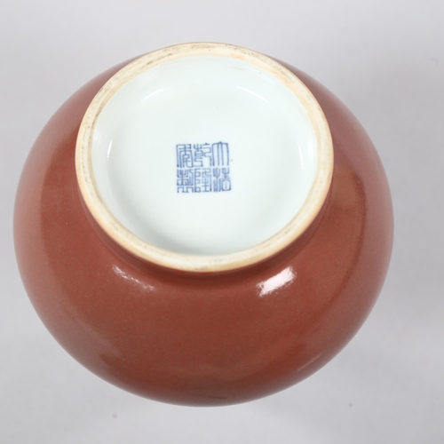 225 - A peach glaze narrow-neck vase, with character marks to base, height 19cm