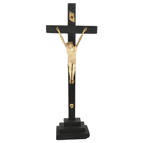 232 - A 19th century bone carved crucifix on ebonised cross, height 48cm