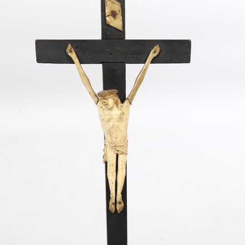 232 - A 19th century bone carved crucifix on ebonised cross, height 48cm