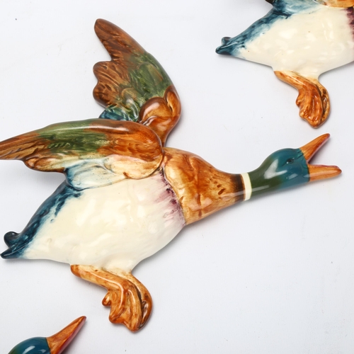 52 - Graduated set of 2 Beswick flying duck wall ornaments, pattern no. 596, largest length 25cm