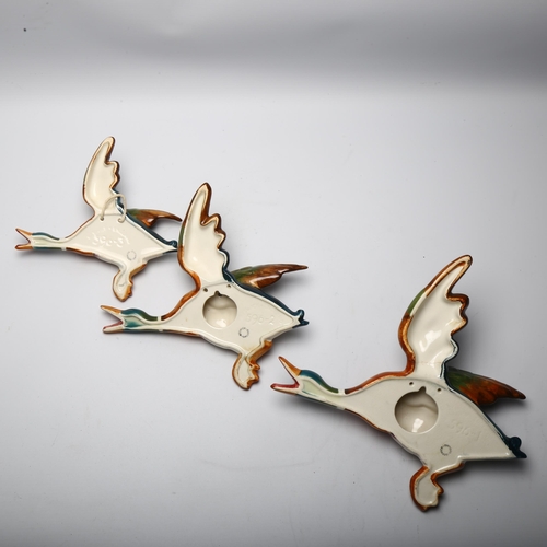 52 - Graduated set of 2 Beswick flying duck wall ornaments, pattern no. 596, largest length 25cm