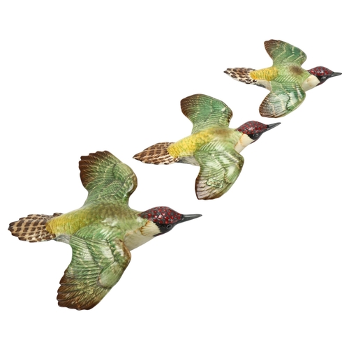 53 - Graduated set of 3 Beswick green woodpecker wall ornaments, pattern no. 1344, largest length 19cm