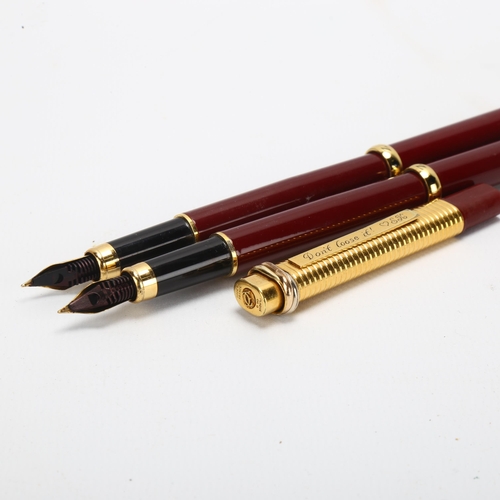 61 - A pair of Morritz burgundy cased fountain pens, and a Cartier gold plated ballpoint pen (3)