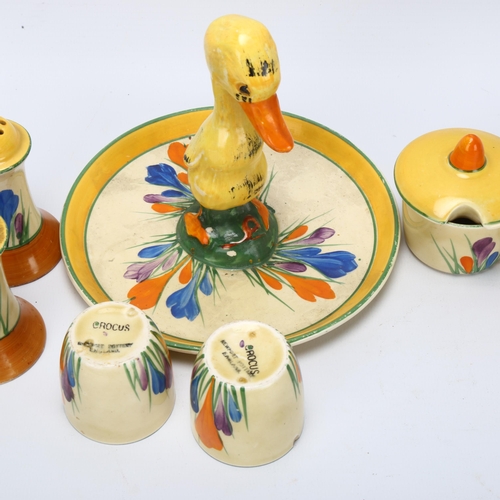 62 - A group of Clarice Cliff Crocus pattern items, including a novelty stand with duckling handle, regis... 