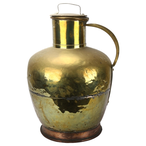 69 - A large Dutch copper and brass flagon and cover, height 58cm