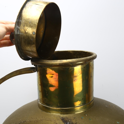 69 - A large Dutch copper and brass flagon and cover, height 58cm