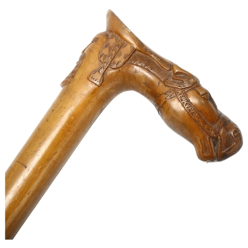 7 - A Russian hardwood walking stick, the handle in the form of a combined horse head saddle and mask, l... 