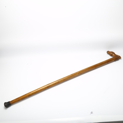 7 - A Russian hardwood walking stick, the handle in the form of a combined horse head saddle and mask, l... 