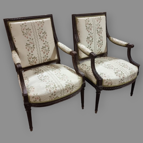 130 - Pair of French salon armchairs, circa 1900, carved walnut show-wood surrounds and silk upholstery