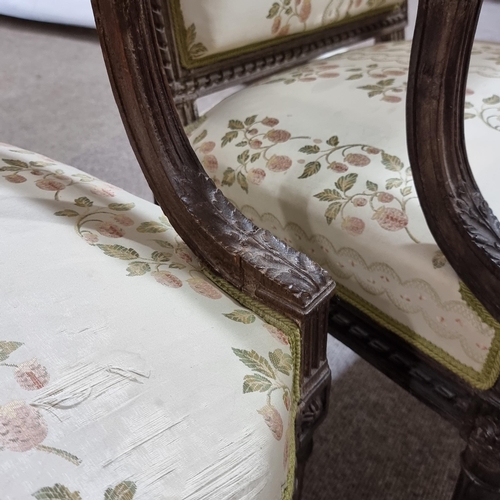 130 - Pair of French salon armchairs, circa 1900, carved walnut show-wood surrounds and silk upholstery