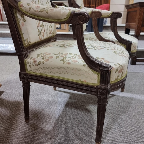 130 - Pair of French salon armchairs, circa 1900, carved walnut show-wood surrounds and silk upholstery