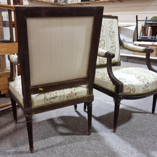 130 - Pair of French salon armchairs, circa 1900, carved walnut show-wood surrounds and silk upholstery