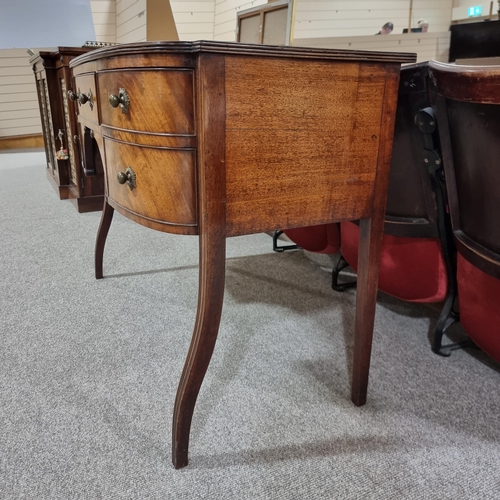 131 - A Regency mahogany bow-front kneehole sideboard of small size, with 5 frieze drawers, original brass... 