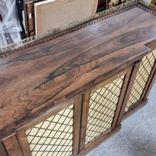 134 - A Regency rosewood break-front 4-door side cabinet, with cast-brass gallery, brass lattice panelled ... 