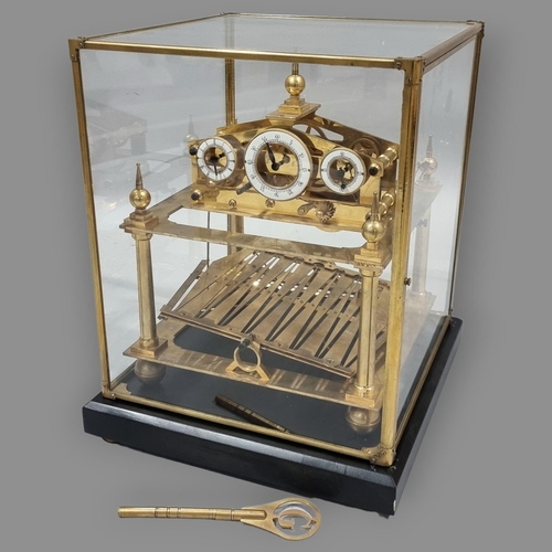 78 - A 20th century brass Congreve clock, with rolling ball fusee movement housed in glass display cabine... 