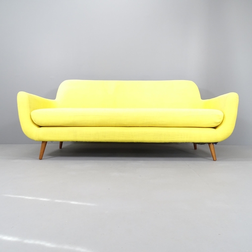 2234 - A mid-century design upholstered three-seater sofa on teak legs, believed to have originally been re... 