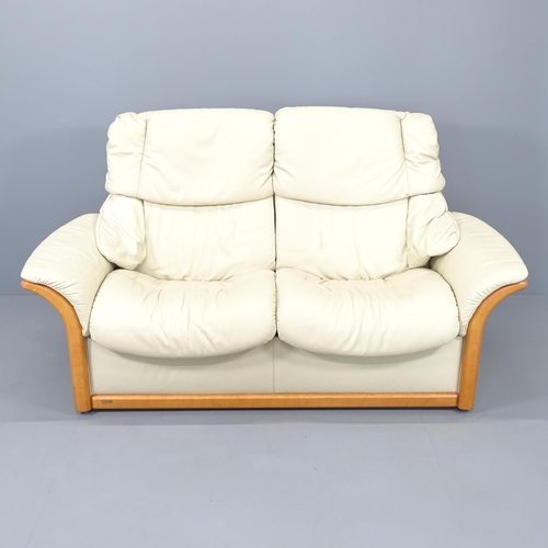 2235 - An Ekornes Stressless Reno two-seater reclining sofa upholstered in cream leather. Overall 174x99x80... 