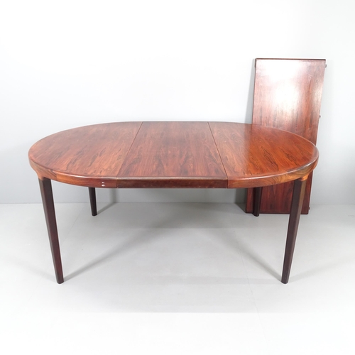 2241 - WITHRAWN - A mid-century Danish rosewood veneered draw-leaf extending dining table with two spare le... 