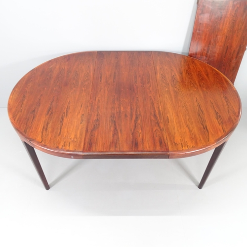 2241 - WITHRAWN - A mid-century Danish rosewood veneered draw-leaf extending dining table with two spare le... 