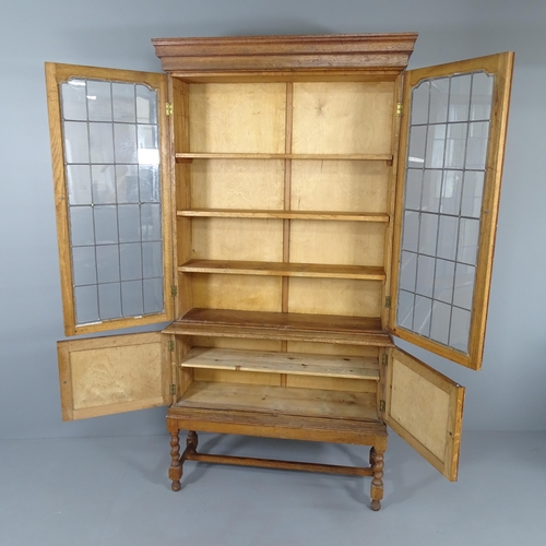 2012 - An early 20th century oak bookcase on stand, with two leadlight glazed doors, three fixed shelves an... 