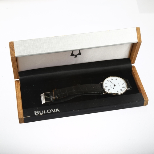 1040 - BULOVA - a stainless steel Longchamp mechanical wristwatch, white dial with Roman numeral hour marke... 