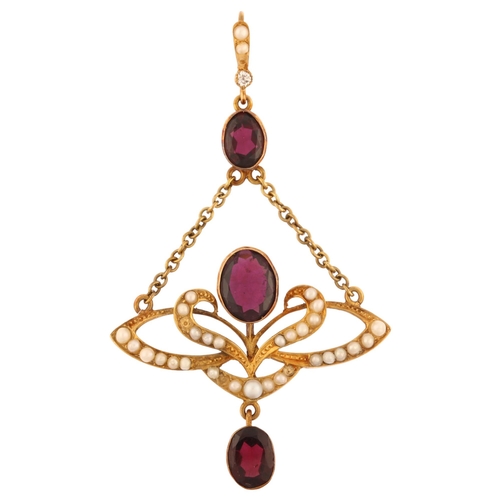 1102 - An Edwardian 15ct gold garnet pearl and diamond openwork drop pendant, with central floral motif set... 