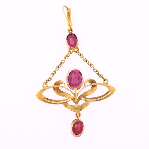 1102 - An Edwardian 15ct gold garnet pearl and diamond openwork drop pendant, with central floral motif set... 