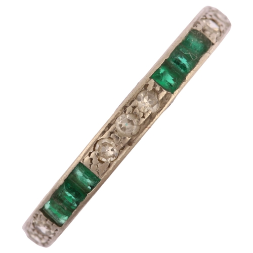 1105 - An emerald and diamond full eternity ring, unmarked white metal settings with trio of single-cut dia... 