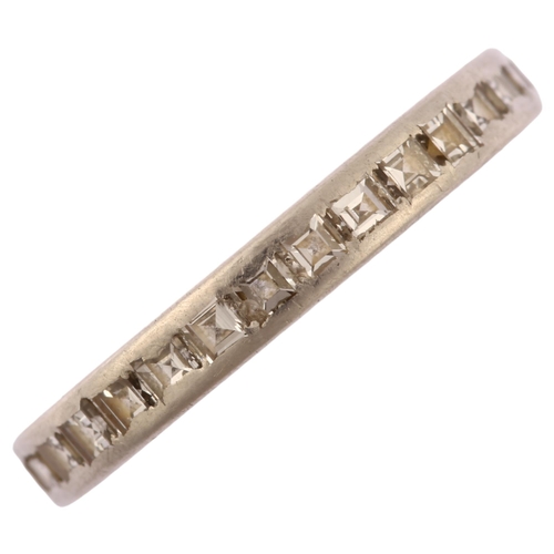 1123 - CARTIER - a diamond full eternity ring, unmarked white metal settings with channel set square step-c... 