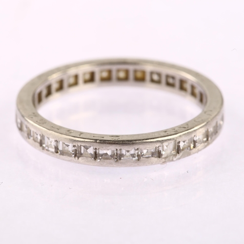 1123 - CARTIER - a diamond full eternity ring, unmarked white metal settings with channel set square step-c... 