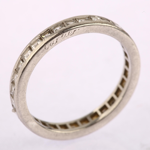 1123 - CARTIER - a diamond full eternity ring, unmarked white metal settings with channel set square step-c... 