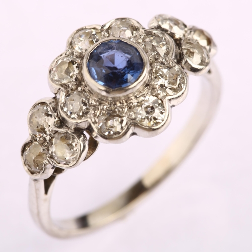 1129 - A sapphire and diamond flowerhead cluster ring, unmarked white metal settings with round-cut sapphir... 