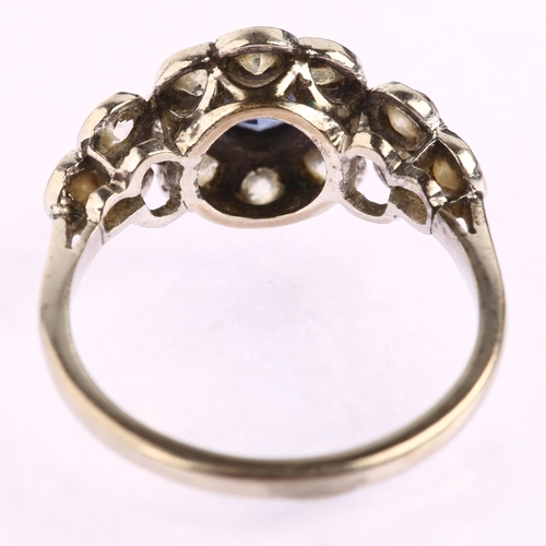 1129 - A sapphire and diamond flowerhead cluster ring, unmarked white metal settings with round-cut sapphir... 