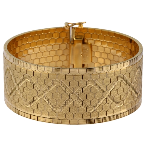 1137 - A heavy Swiss 18ct gold cuff bracelet, polished and textured hexagonal links with engraved lozenge d... 