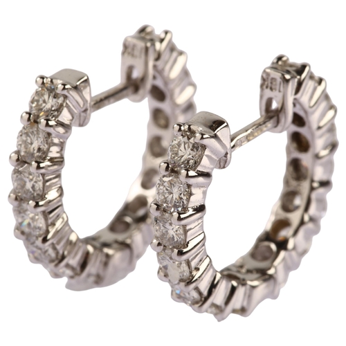 1147 - A pair of 18ct white gold diamond hoop earrings, set with modern round brilliant-cut diamonds, total... 