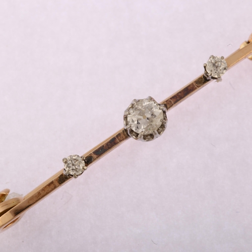 1149 - An early 20th century 9ct gold three stone diamond bar brooch, claw set with old European-cut diamon... 