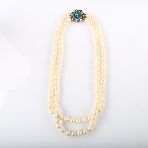 1176 - A double-strand cultured pearl necklace, with unmarked gold pearl diamond and blue enamel clasp, tot... 