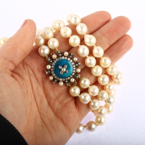 1176 - A double-strand cultured pearl necklace, with unmarked gold pearl diamond and blue enamel clasp, tot... 